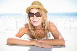 Pretty blonde relaxing beside the water looking at camera