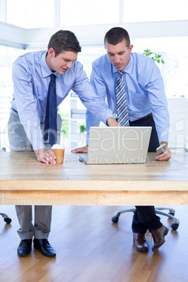 Businessmen using laptop