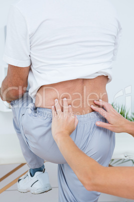 Doctor examining her patient back