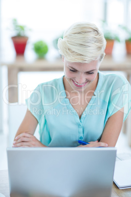 Businesswoman using laptop in the office