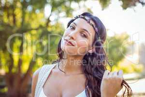 Pretty hipster smiling in the park