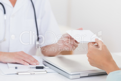 Doctor giving prescription to her patient