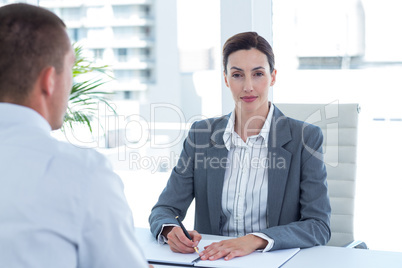 Businesswoman conducting an interview with businessman