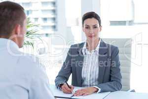 Businesswoman conducting an interview with businessman