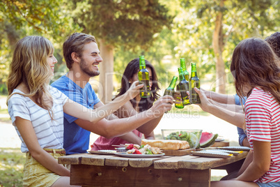 Happy friends in the park having lunch