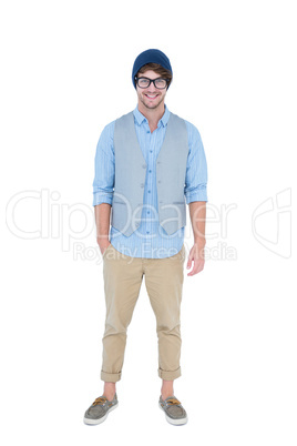 Geeky hipster looking at camera with hand in pocket