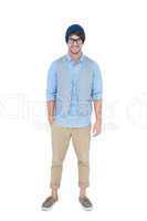 Geeky hipster looking at camera with hand in pocket