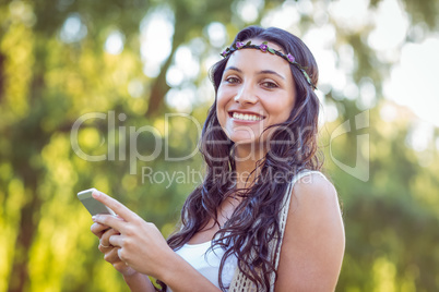 Pretty hipster using her smartphone