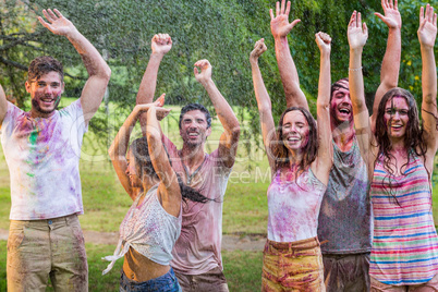 Happy friends covered in powder paint