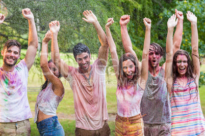 Happy friends covered in powder paint