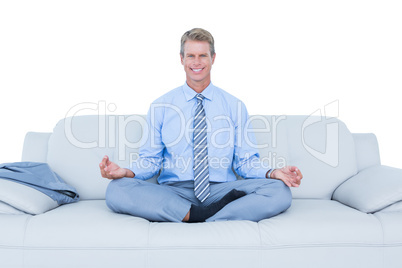 businessman meditating in yoga pose