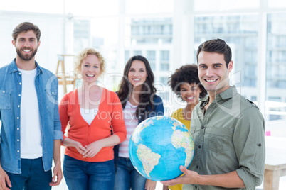 Young creative business people with a globe