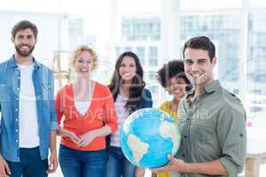 Young creative business people with a globe
