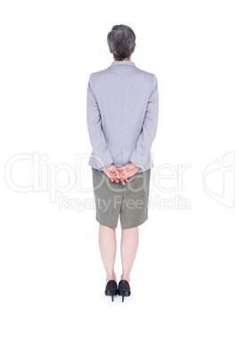 Wear view of businesswoman standing with hand on back