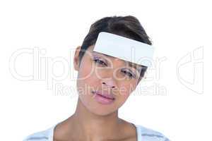 Pretty brunette looking at camera with paper on head