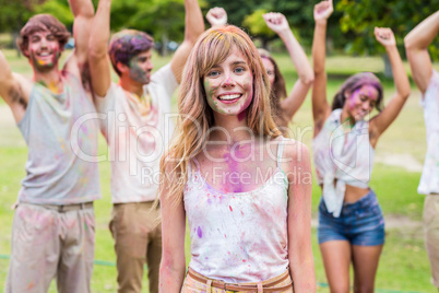 Happy friends throwing powder paint