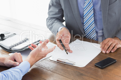 Businessman explaining contract to co worker