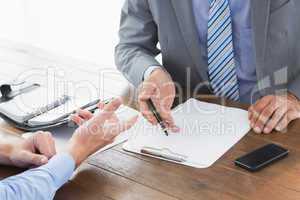 Businessman explaining contract to co worker