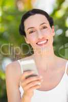 woman in white looking at her phone