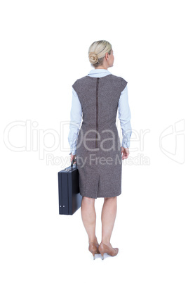 Back turned businesswoman holding a briefcase