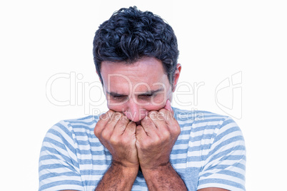 Stressed man with hands in front of his mouth