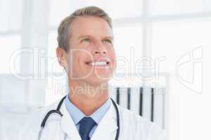 Smiling doctor looking at top