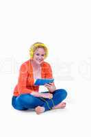 Pretty blonde listening music with her tablet computer