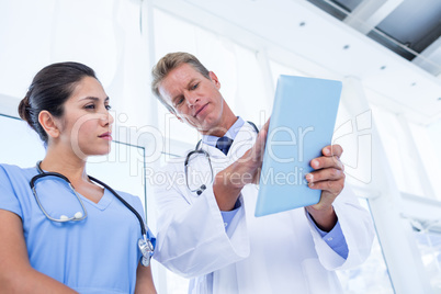 Serious doctors looking at clipboard