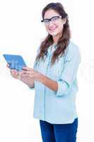 Pretty geeky hipster smiling at camera and holding tablet