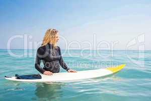 woman with a surfboard on a sunny day