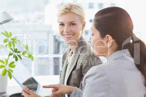 Businesswomen using tablet