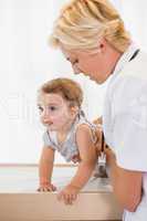 Blonde doctor with a child and stethoscope