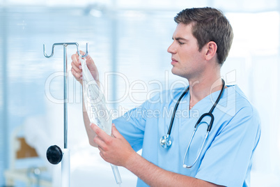 Doctor examining intravenous drip