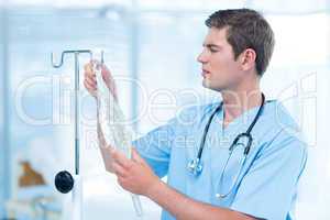 Doctor examining intravenous drip