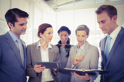 Business people with tablet and notebook