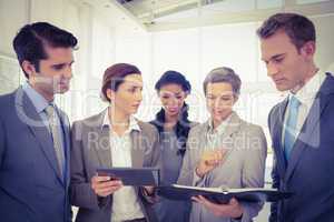 Business people with tablet and notebook