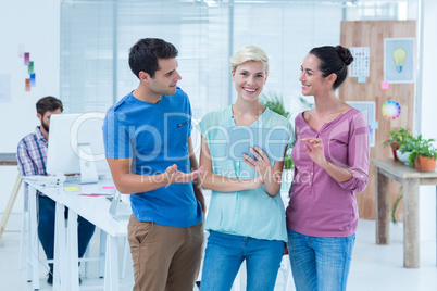 Three casual colleagues using digital tablet