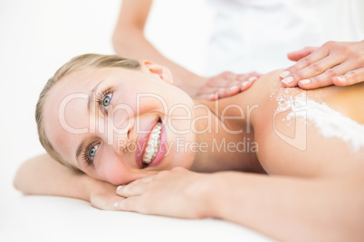 Beautiful woman receiving stone massage at spa center