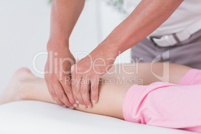 Physiotherapist doing calf massage