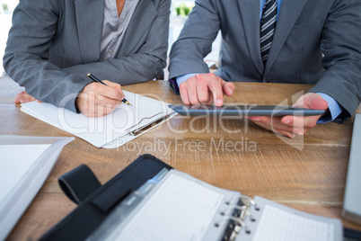 Business people using tablet in office