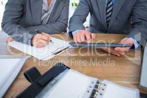 Business people using tablet in office