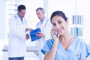 Smiling femal doctor phoning