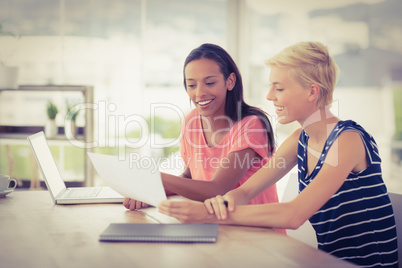 Two smiling businesswomen working together