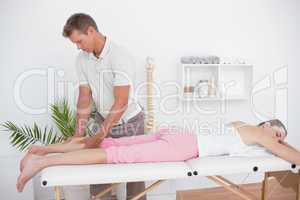 Physiotherapist doing calf massage