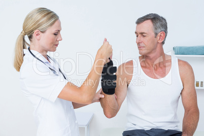 Doctor examining a man wrist