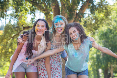 Happy friends covered in powder paint