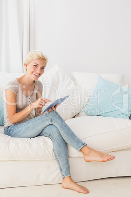 Portrait smiling blonde woman using digital tablet