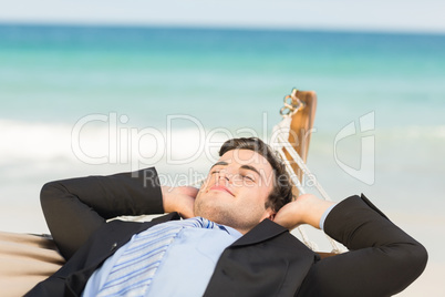 Happy businessman relaxing on the hammock