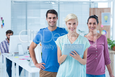 Three casual colleagues using digital tablet