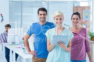 Three casual colleagues using digital tablet